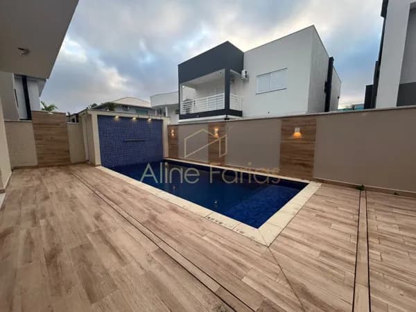 Casa moderna com 3 suítes, piscina e área gourmet completa em condomínio á venda em Peruíbe