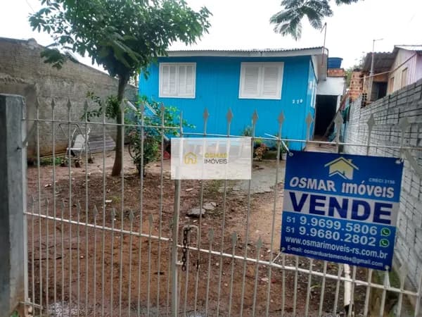 Casa de madeira com 3 dormitórios no bairro Auxiliadora, Gravataí/RS.