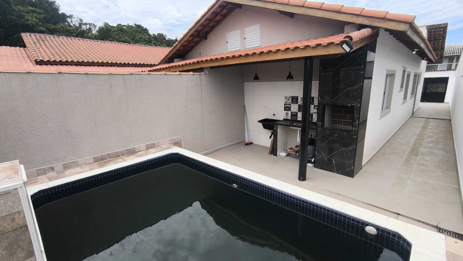Casa em bairro residencial com piscina à venda em Itanhaém/SP.